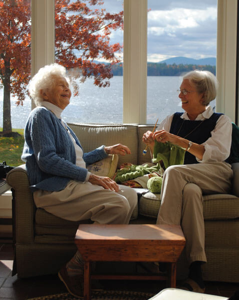 two old women laughing in sunroom