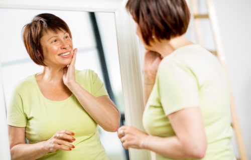 woman smiling in a mirror